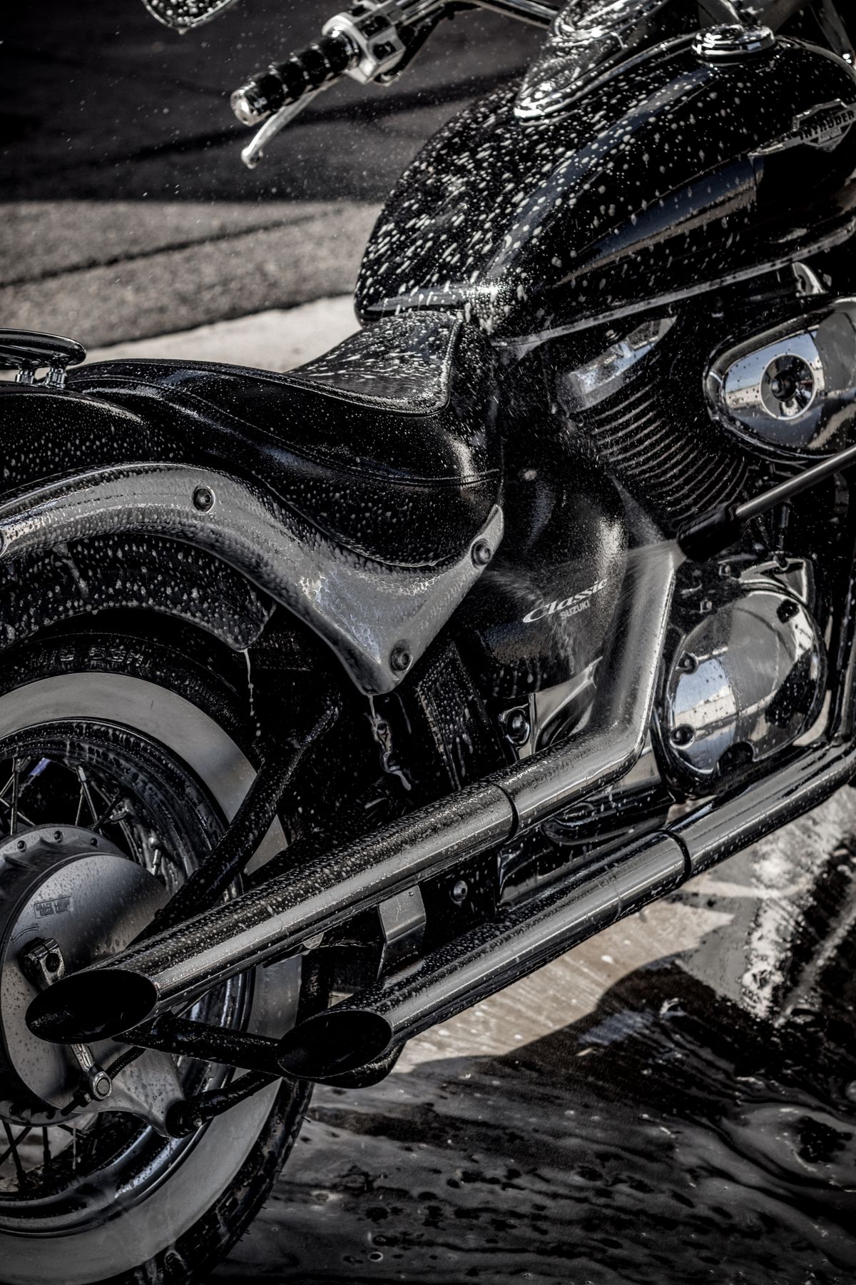 Close-up of foam on motorcycle chrome and paint during washing