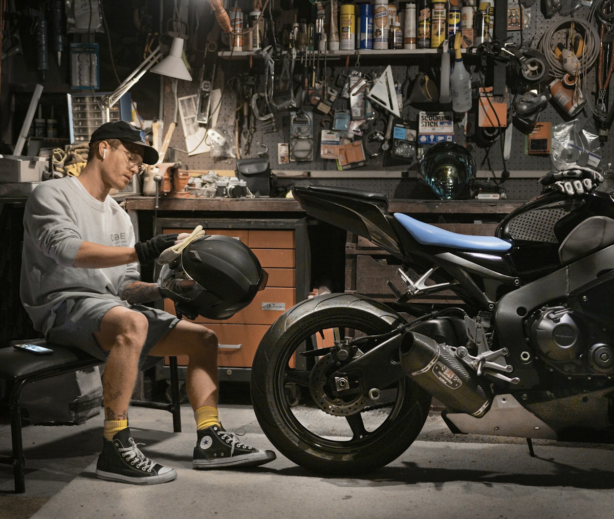 Detailer wiping down a motorcycle after washing