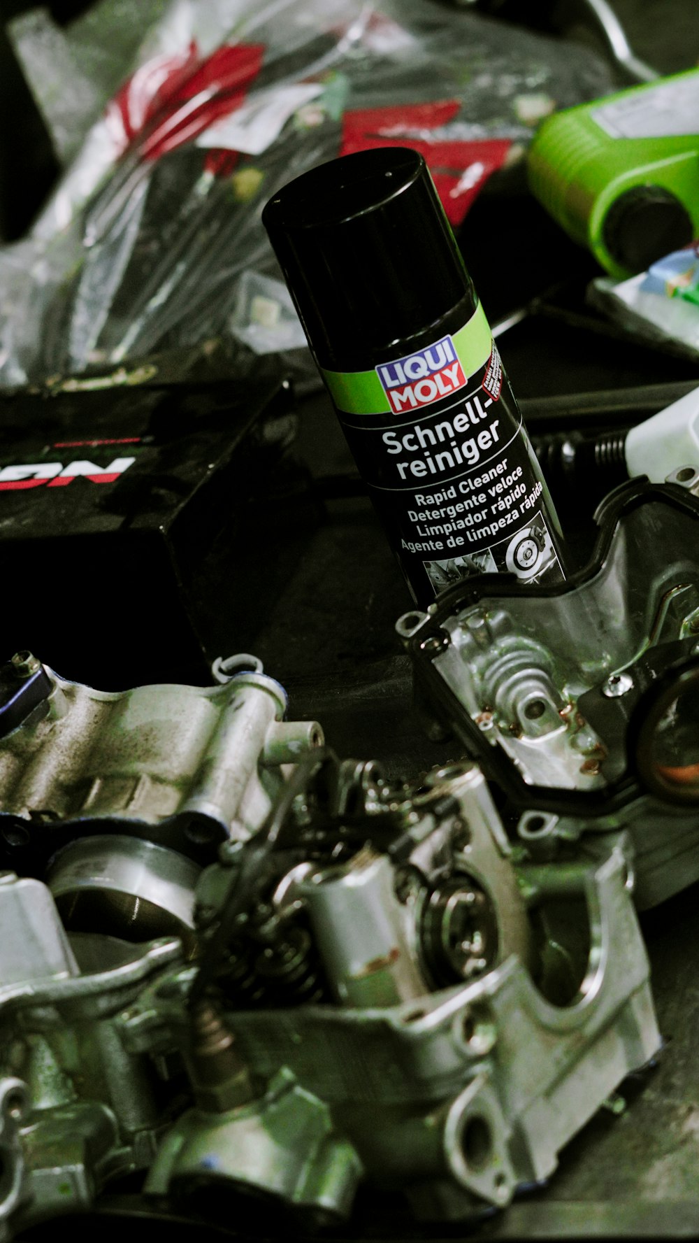 Degreaser being sprayed on motorcycle engine parts