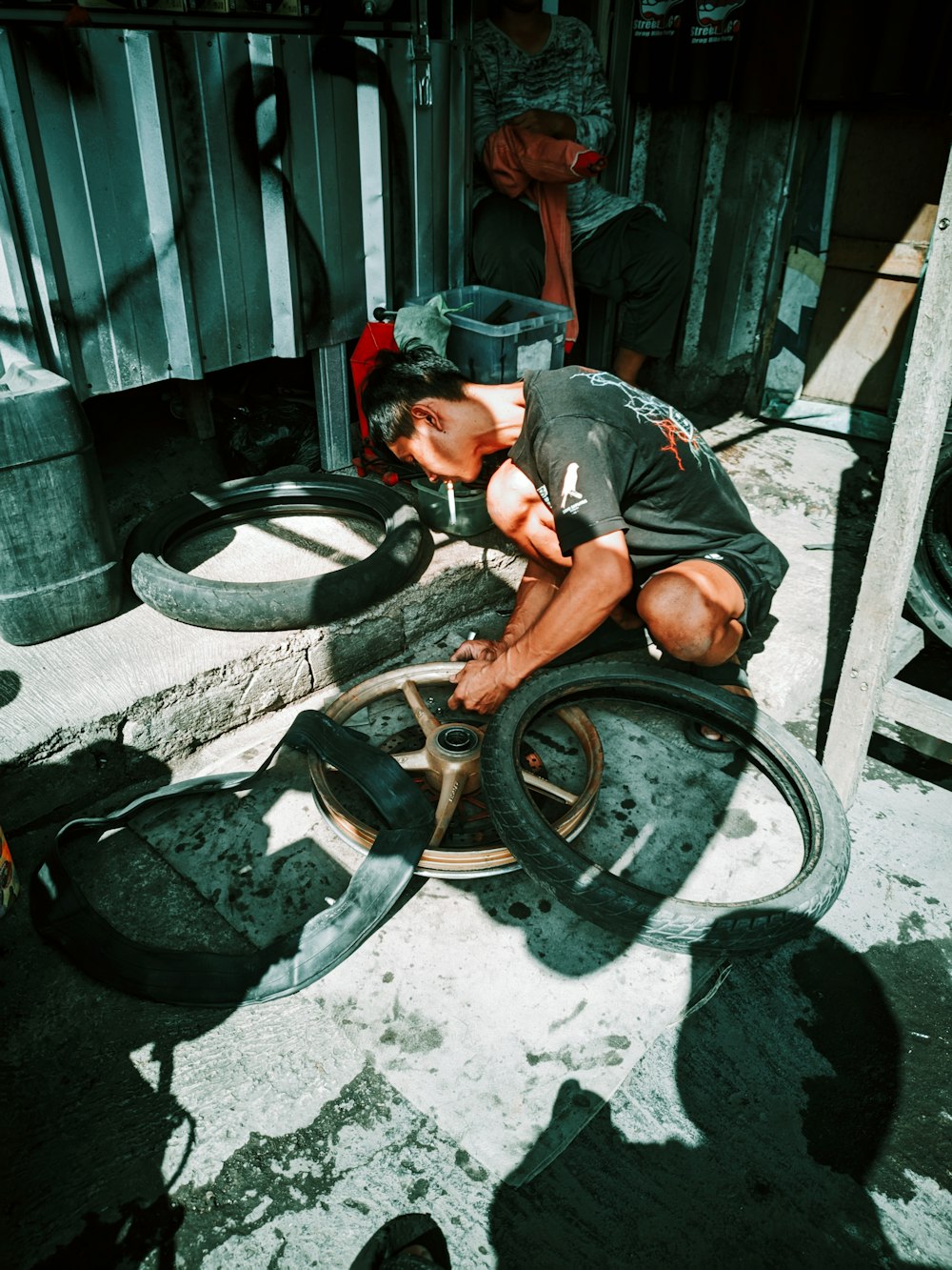 Technician repairing motorcycle wheels and tyres in a workshop
