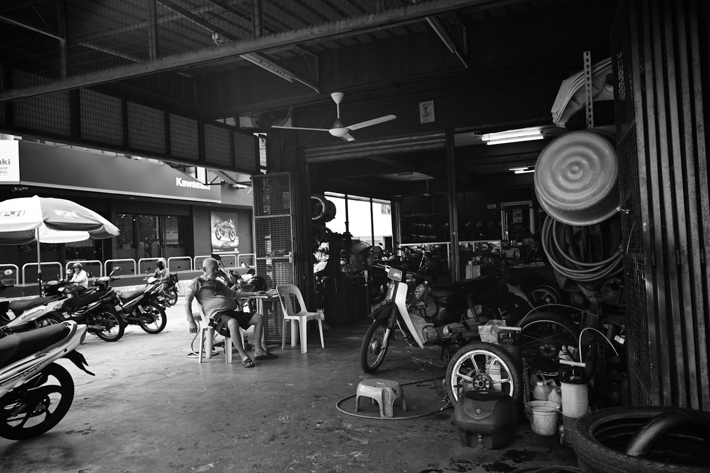 Motorcycles lined up inside a garage waiting for service